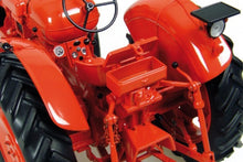 Load image into Gallery viewer, Close up of a red Nuffield Universal 4 tractor model showing the steering wheel rear linkage and large treaded tyres from Universal Hobbies in 1:16 scale