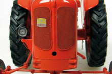 Load image into Gallery viewer, Front view of a red Nuffield Universal tractor model with large black tyres and detailed grille from Universal Hobbies in 1:16 scale