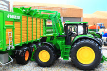 Load image into Gallery viewer, Siku 1:32 scale John Deere tractor with green front loader, shown beside a matching farm trailer in a detailed miniature farm scene