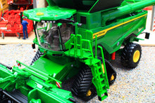 Load image into Gallery viewer, Britains John Deere S7 900 tracked combine harvester model in 1:32 scale with green body yellow wheels and detailed header on a farm display scene
