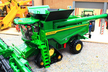 Load image into Gallery viewer, Britains John Deere S7 900 tracked combine harvester model in green with yellow details and unloading auger displayed with its cutting header