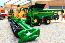 Load image into Gallery viewer, Britains John Deere S7 900 tracked combine harvester model with a wide cutting header displayed in a detailed farm machinery scene