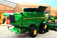 Load image into Gallery viewer, Britains John Deere S7 900 tracked combine harvester model in green with yellow wheels displayed among miniature farm machinery in a farm diorama
