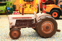 Load image into Gallery viewer, Weathered Britains David Brown 990 2WD Selectamatic tractor model in brown and cream displayed on gravel with farm machinery in the background
