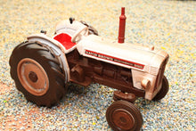 Load image into Gallery viewer, Britains weathered David Brown 990 2WD tractor model in 1:32 scale displayed on a textured farm diorama surface
