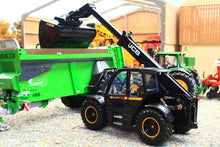 Load image into Gallery viewer, Britains 1:32 scale black JCB 542 70 AgriPro Loadall model with front bucket beside a green farm trailer in a realistic agricultural setting