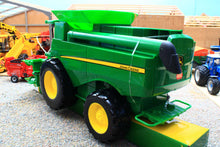 Load image into Gallery viewer, Britains John Deere combine toy in green with yellow wheels displayed in a farm scene suitable as a preschool farm toy for ages 3 and up
