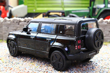 Load image into Gallery viewer, Burago 1 43 scale black Land Rover Defender 110 model vehicle with spare wheel displayed on gravel in a detailed farm diorama setting