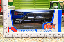 Load image into Gallery viewer, Burago 1:43 scale black Land Rover Defender 110 diecast model in retail packaging, displayed against a miniature farm scene