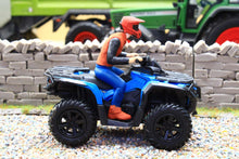 Load image into Gallery viewer, Diecast Masters 1:32 scale blue quad bike with a rider in a red helmet and blue clothing displayed in a farm diorama beside a stone wall