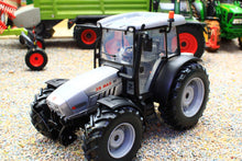 Load image into Gallery viewer, ROS 1:32 scale XB Max 100 4WD tractor model in silver and black with detailed cab and chunky tyres displayed in a miniature farm scene