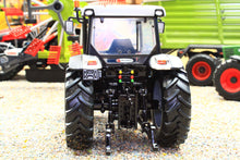 Load image into Gallery viewer, Rear view of a ROS 1:32 scale farm tractor model showing large treaded tyres three point hitch and detailed cab in a miniature farm display