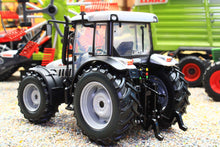 Load image into Gallery viewer, ROS 1:32 scale black and white 4WD tractor model with large treaded tyres displayed among miniature farm machinery