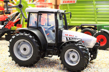 Load image into Gallery viewer, ROS 1:32 scale XB Max 100 4WD tractor model in black and white with chunky tyres displayed on a farm diorama