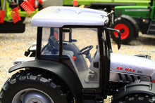 Load image into Gallery viewer, Close view of a ROS 1:32 scale XB Max 100 4WD tractor model showing its cab steering wheel and rugged tyres among farm machinery