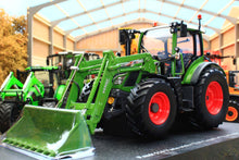 Load image into Gallery viewer, Universal Hobbies Fendt 516 Vario 4WD tractor model with front loader and bucket displayed inside a farm machinery shed