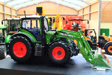Load image into Gallery viewer, Universal Hobbies Fendt 516 Vario 4WD tractor model with front loader displayed in a farm machinery showroom. 1:32 scale collectible tractor model.