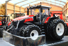 Load image into Gallery viewer, Universal Hobbies Massey Ferguson 9S.425 4WD tractor model with large treaded tyres, displayed in a bright showroom as a 1:32 scale agricultural model