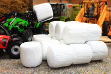 Load image into Gallery viewer, Universal Hobbies 1:32 scale white wrapped round silage bales in a farm diorama with machinery shown for display only. Only the bales are included.