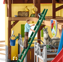 Load image into Gallery viewer, Man on ladder inside the SL42485 Schleich Farm World Stable with Figures, Anamals and Accessories